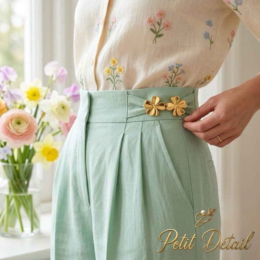 Gold Clover Waist Buckle worn at the waistband of mint-green trousers