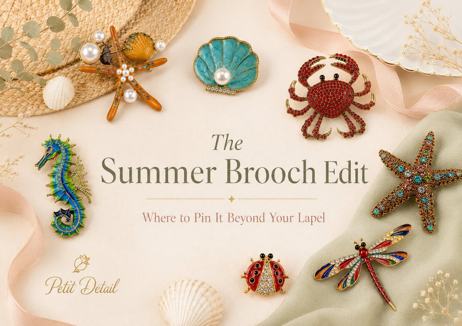 A flat-lay of colourful summer brooches — seahorse, starfish, shell, crab, ladybird and dragonfly — for the Petit Détail Summer Brooch Edit