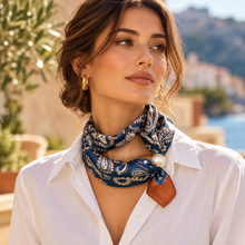 Navy paisley magnetic scarf with pearl clasp styled over an ivory blouse, from Just Arrived.