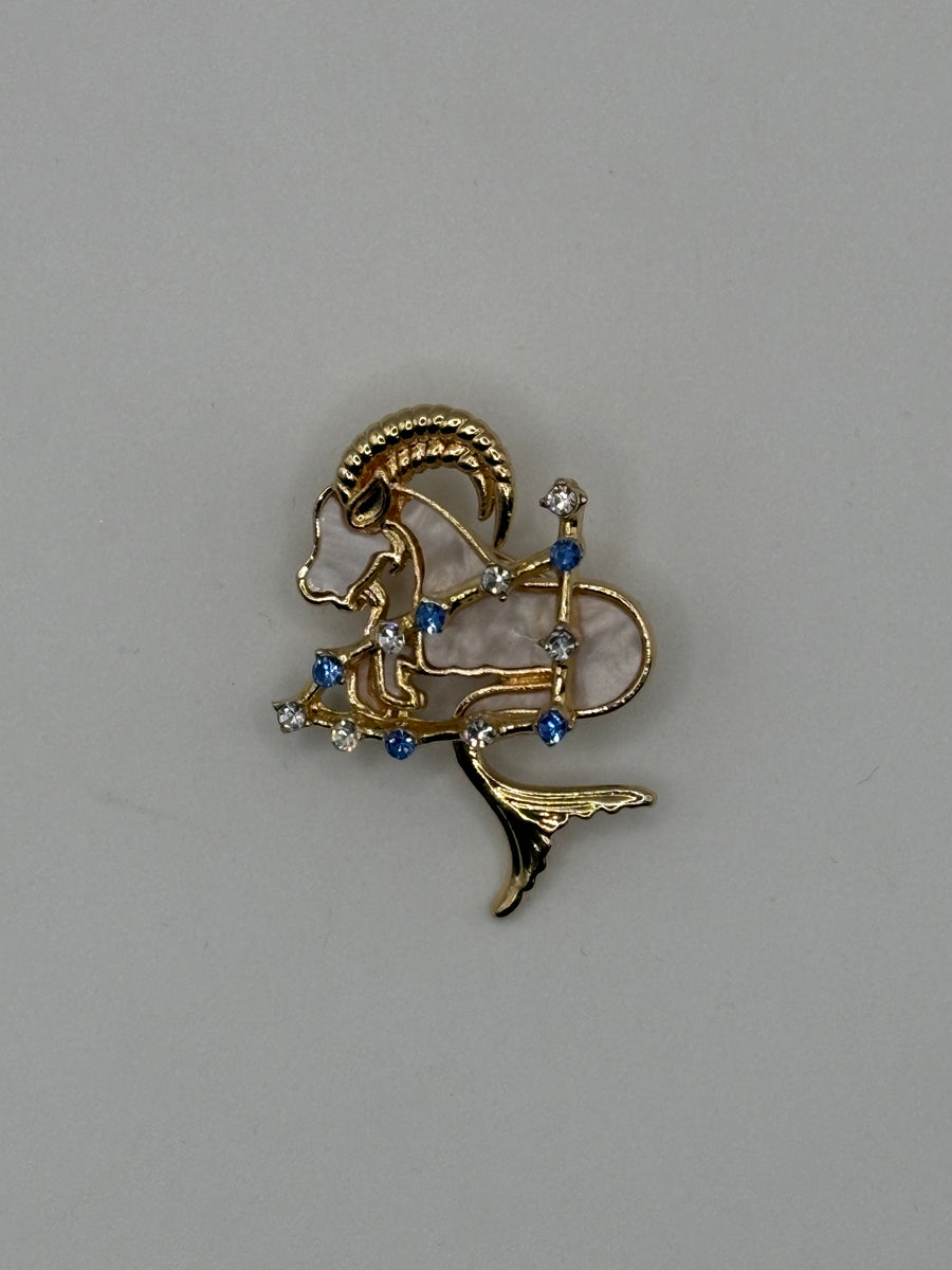 Capricorn Zodiac Brooch | Gold Sea-Goat Horoscope Pin with Mother of Pearl – gold fashion jewelry, main product image, Petit Détail