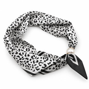 Black and ivory leopard print magnetic scarf with pearl magnetic closure on white background