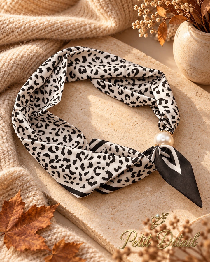 Black and ivory leopard print magnetic scarf with pearl magnetic closure on white background