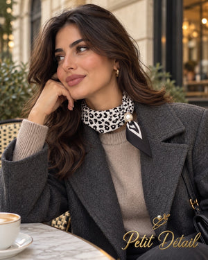 Woman wearing black and ivory leopard print magnetic scarf with pearl closure