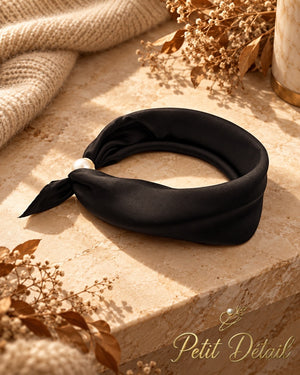 Black satin magnetic scarf styled with pearl magnetic closure in a warm autumn setting