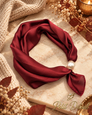Burgundy satin magnetic scarf styled with pearl magnetic closure in a warm autumn setting