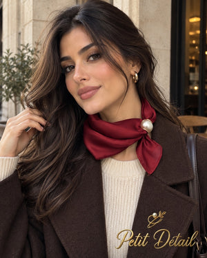 Woman wearing burgundy satin magnetic scarf with pearl closure
