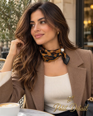 Woman wearing caramel and black leopard print magnetic scarf with pearl closure
