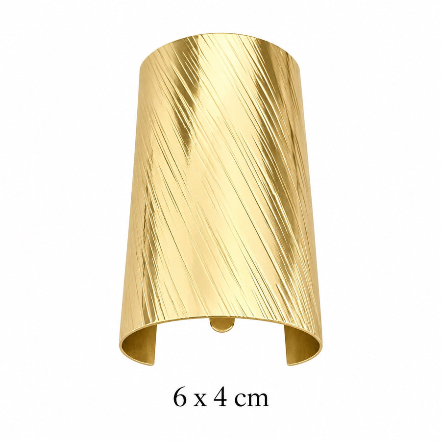 Wide diagonal brushed gold-tone hair cuff with open back on white background, 6 x 4 cm