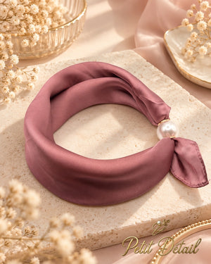 Dusty rose magnetic scarf with pearl magnetic closure styled in a soft neutral setting
