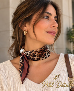 Woman wearing leopard print magnetic scarf with pearl closure