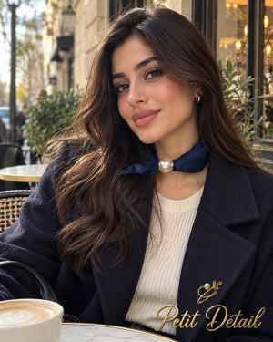 Woman wearing navy blue satin magnetic scarf with pearl closure