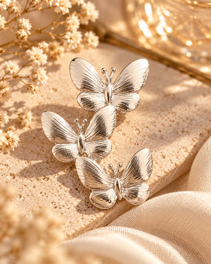 Silver triple butterfly brooch styled product photo