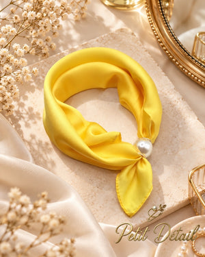 Sunshine yellow magnetic scarf with pearl magnetic closure styled in a warm neutral setting