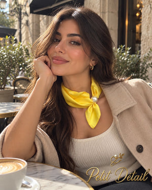 Woman wearing sunshine yellow magnetic scarf with pearl closure