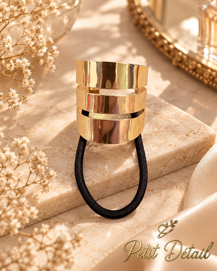 Polished gold-tone triple-band hair cuff with black elastic on white background, 4 x 4 cm